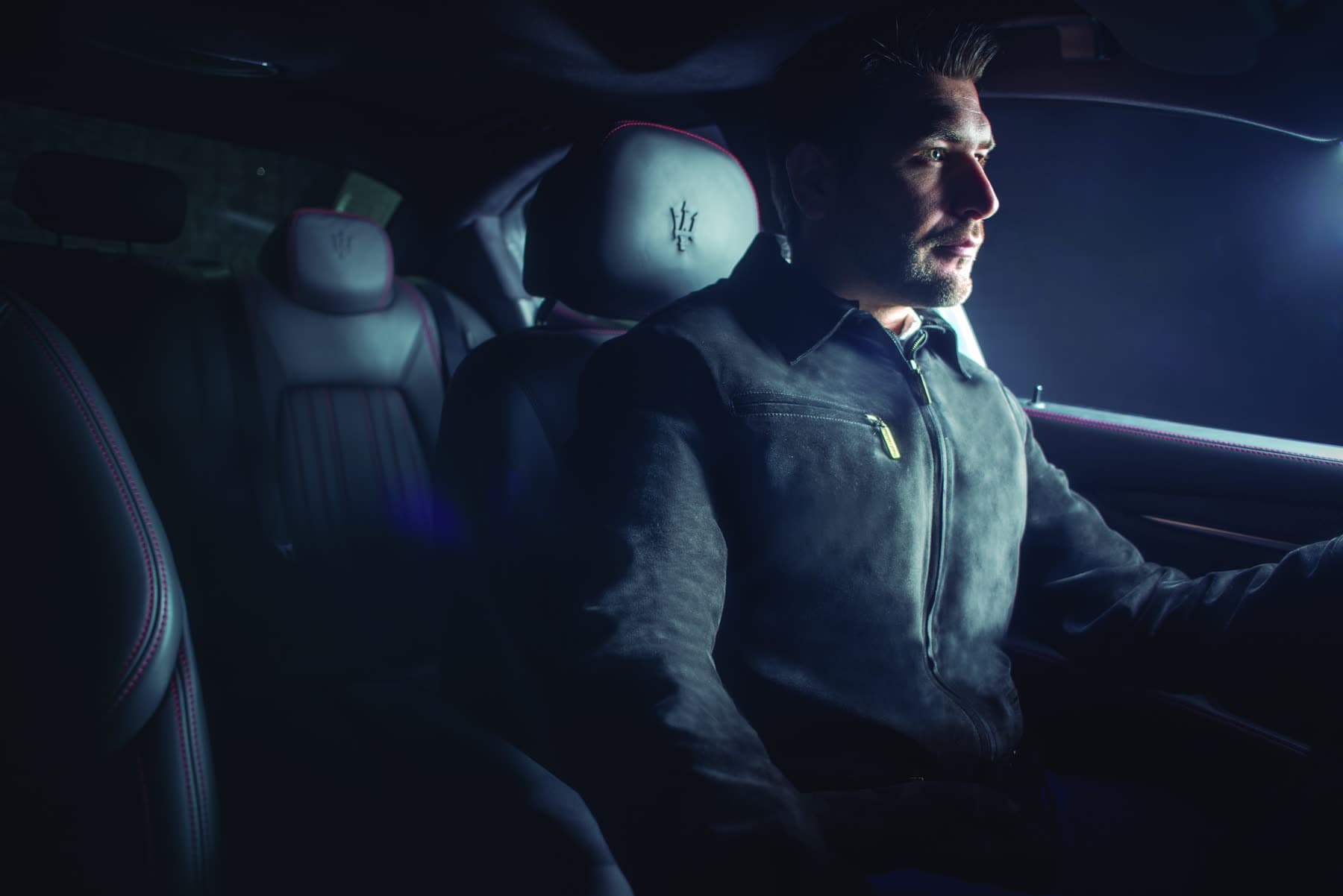 A passenger in the back of a car wearing MC Armor